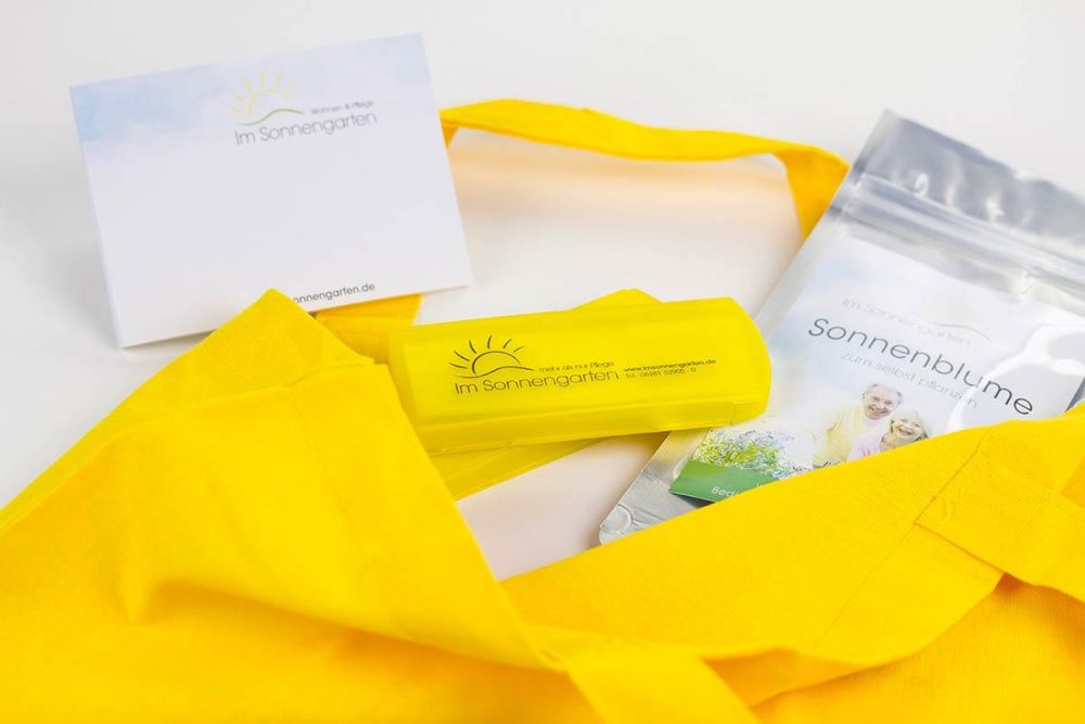 Pflasterdose, Gelbe Stofftasche und Sonnenblumen Pflanzlinge